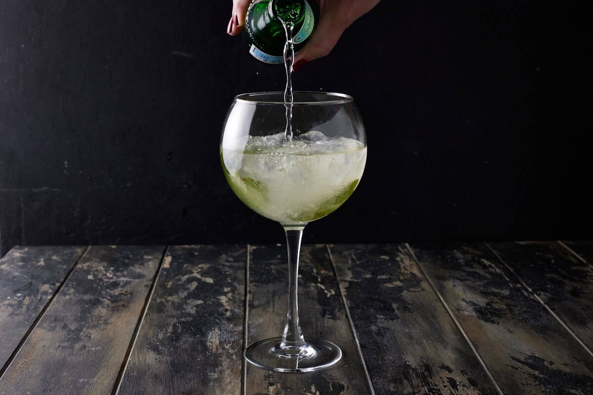 Hugo spritz cocktail topped with sparkling water. 