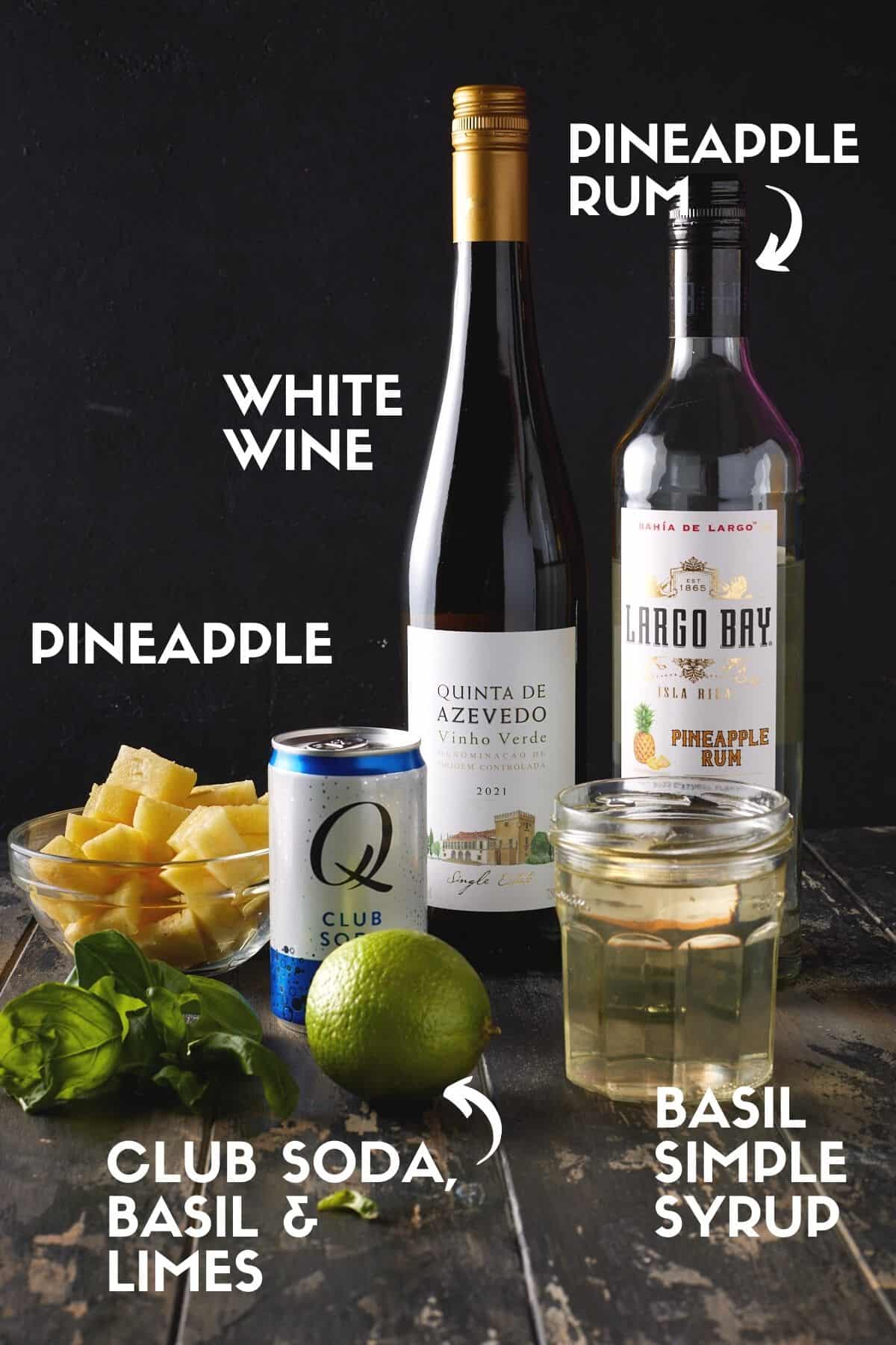 Ingredients for white wine sangria including wine, rum, pineapple and club soda. 