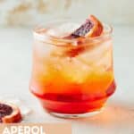 Single Aperol Soda in low ball glass filled with ice.