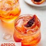 Low ball glasses filled with Aperol and Soda with blood oranges.