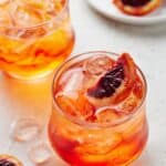 Low ball glasses will with Aperol sodas with ice and blood oranges.