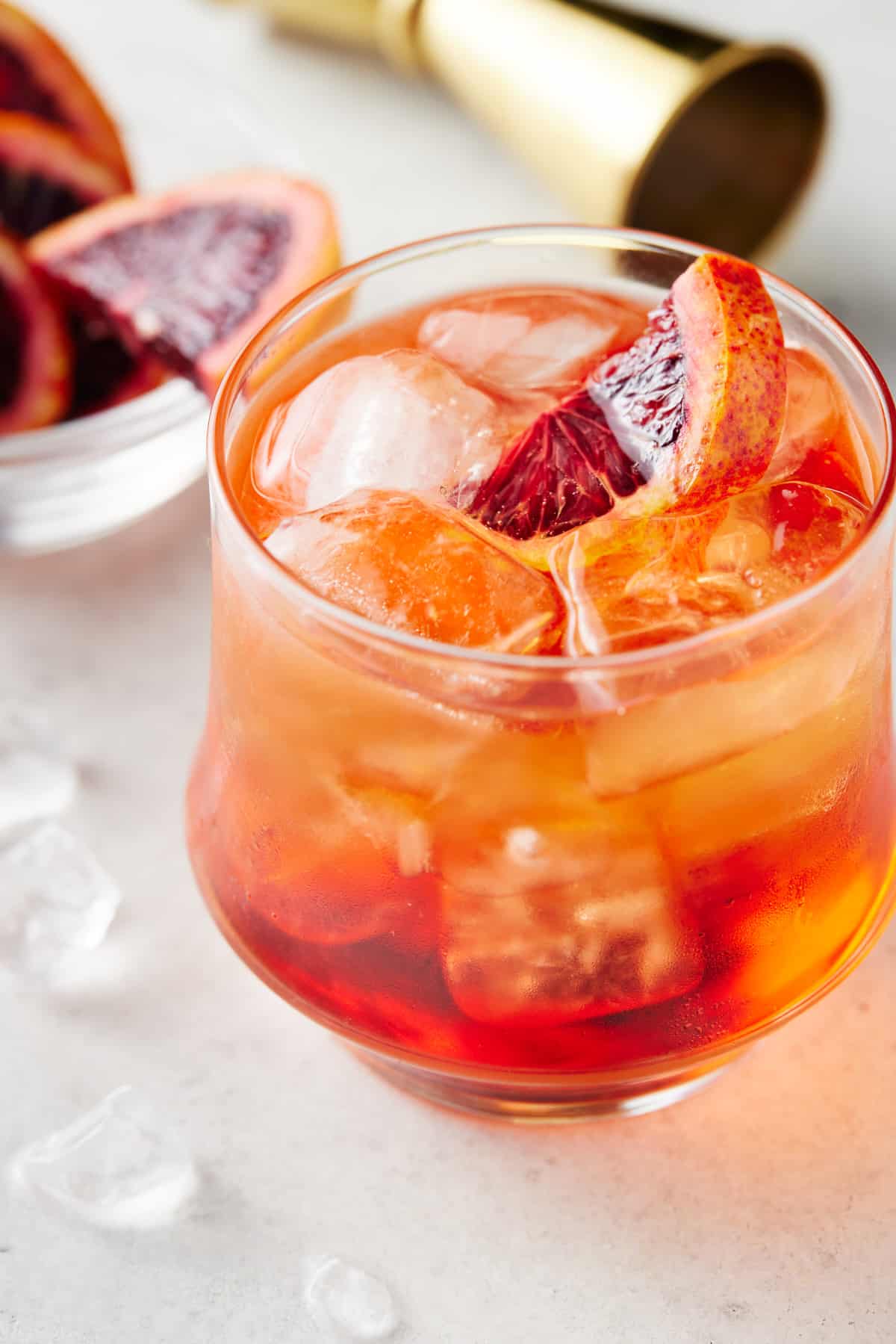 Aperol and soda in a low ball glass with a blood orange slice.