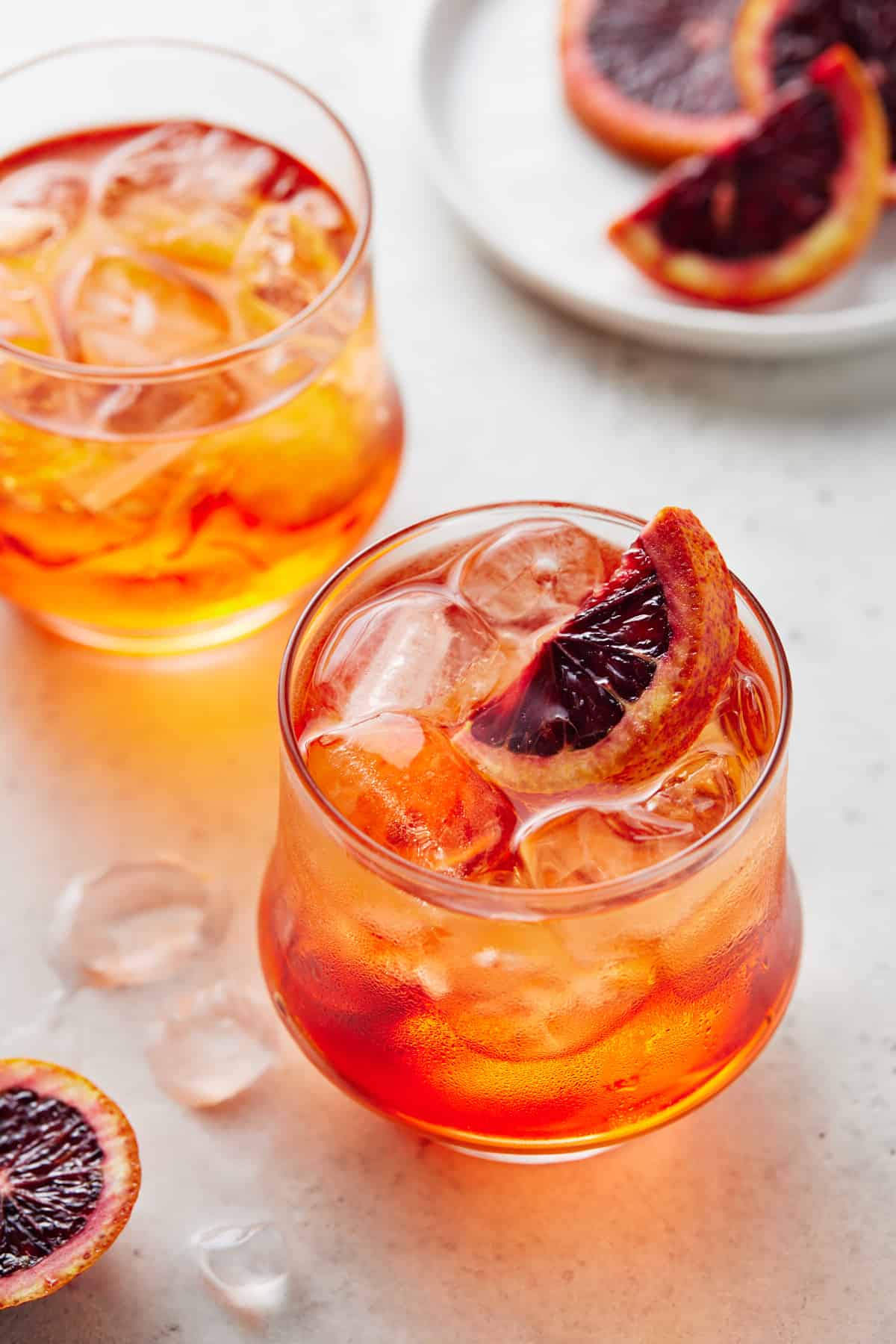 Aperol Sodas in low ball glasses with ice and orange slices.