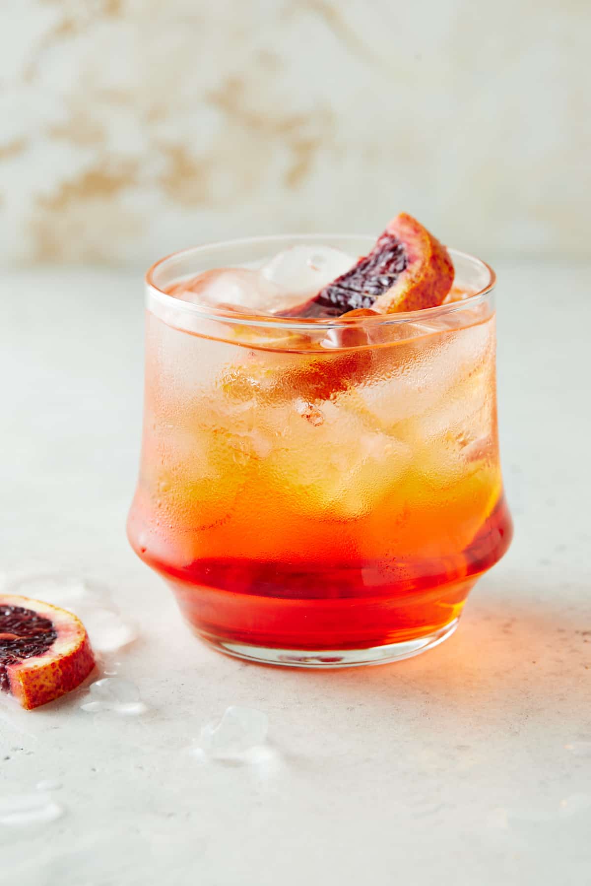 Aperol soda in a low ball glass with orange slices.