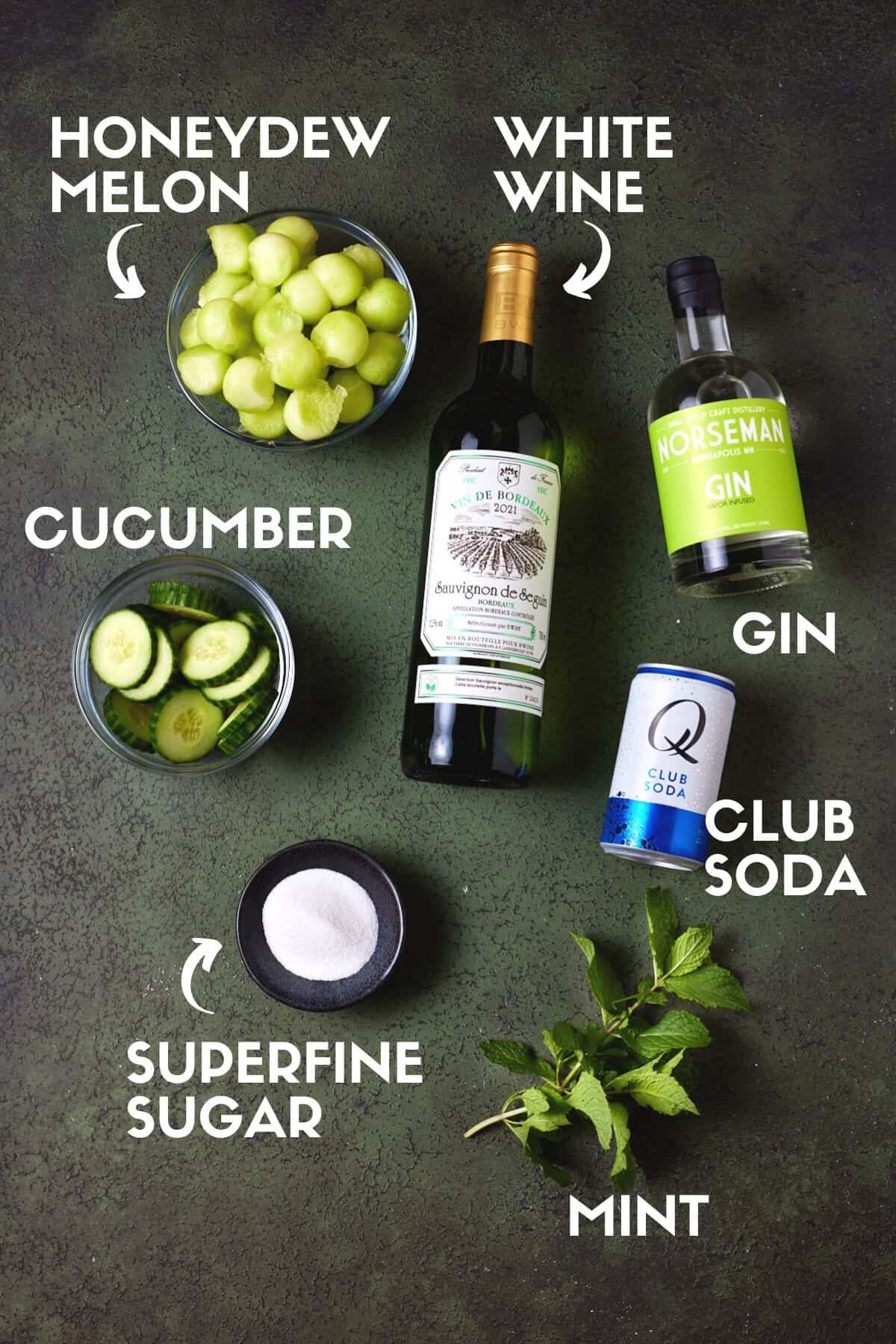 Ingredients for spa water sangria including honeydew melon, white wine, mint and cucumber. 