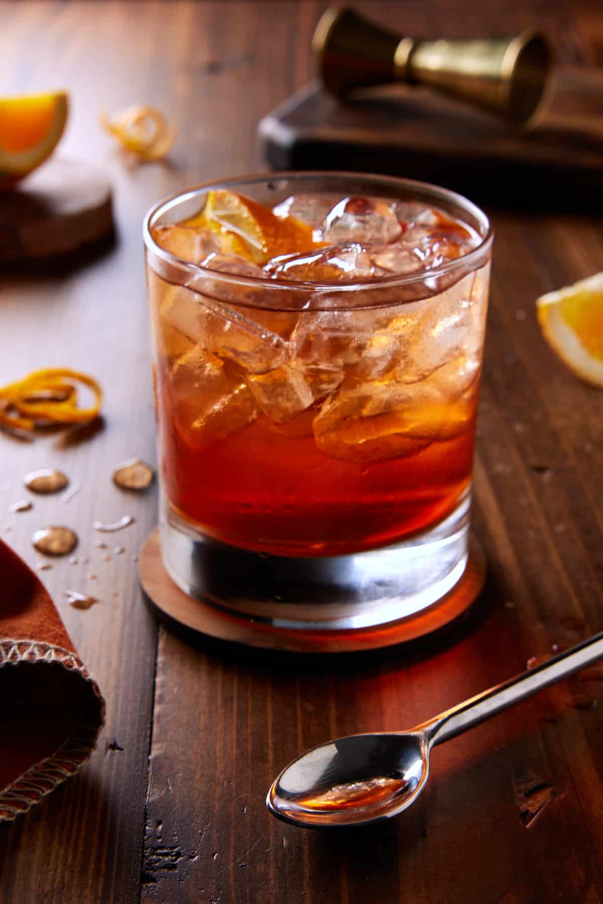 Lowball glass filled with aperol, bourbon and club soda and garnished with orange wedge. 