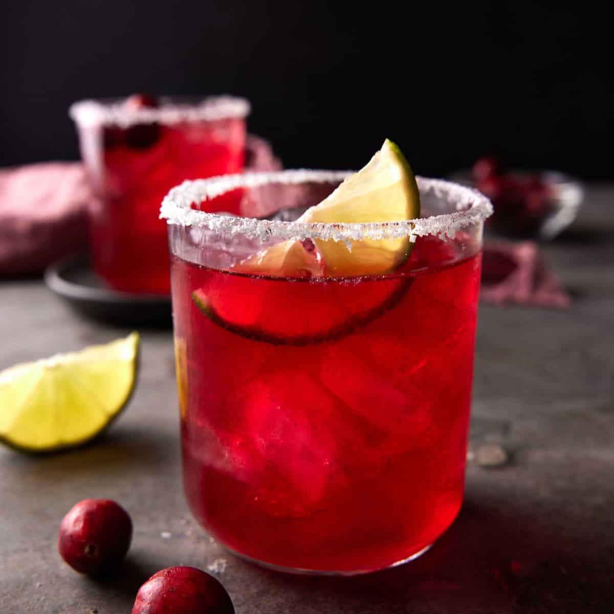 cranberry margarita in a low ball glass.