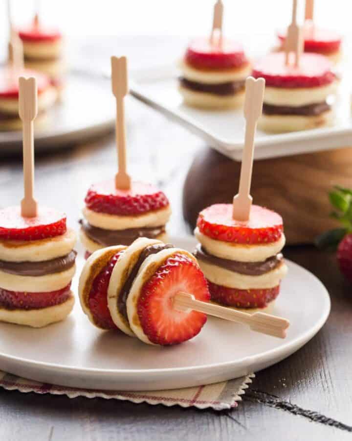 Mini pancake skewers with sliced strawberries and Nutella.