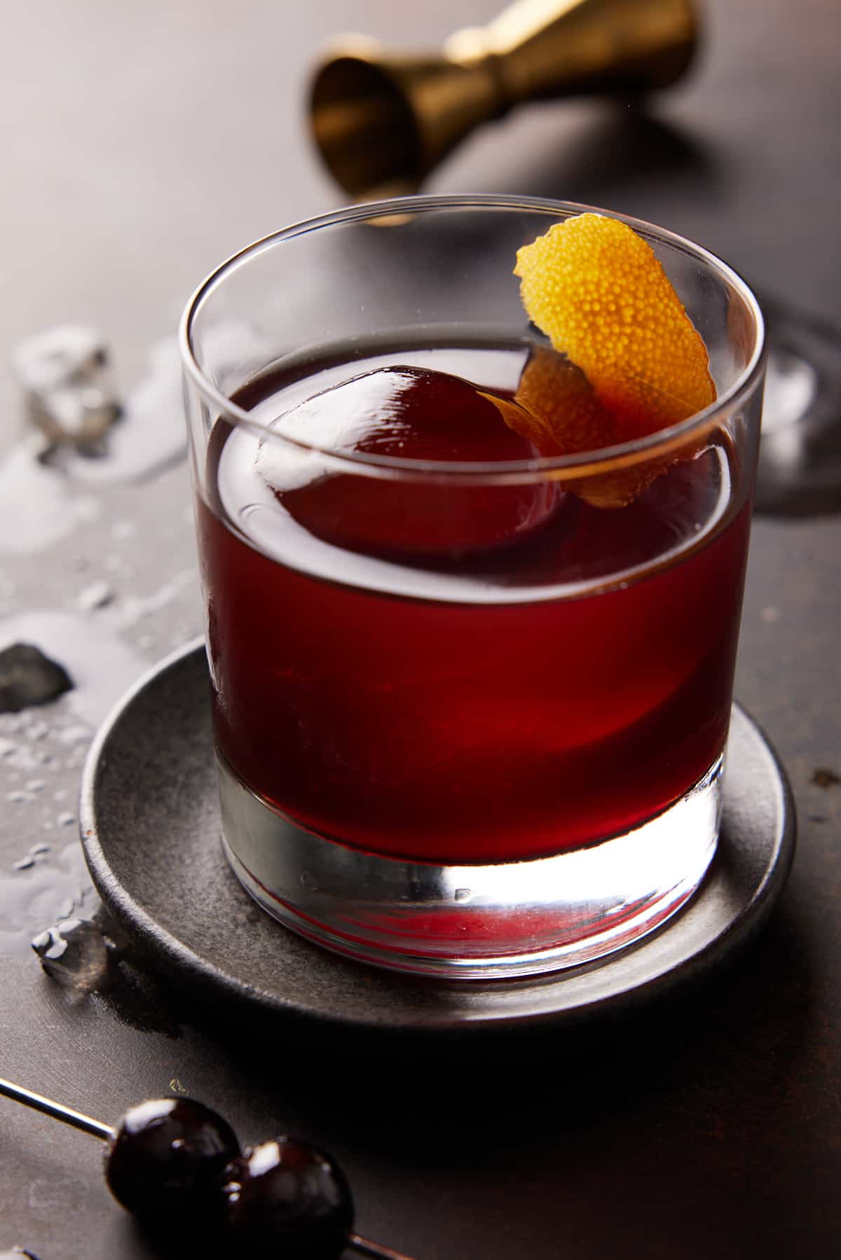 Single Brandy Old Fashioned with cherry juice in low ball glass.