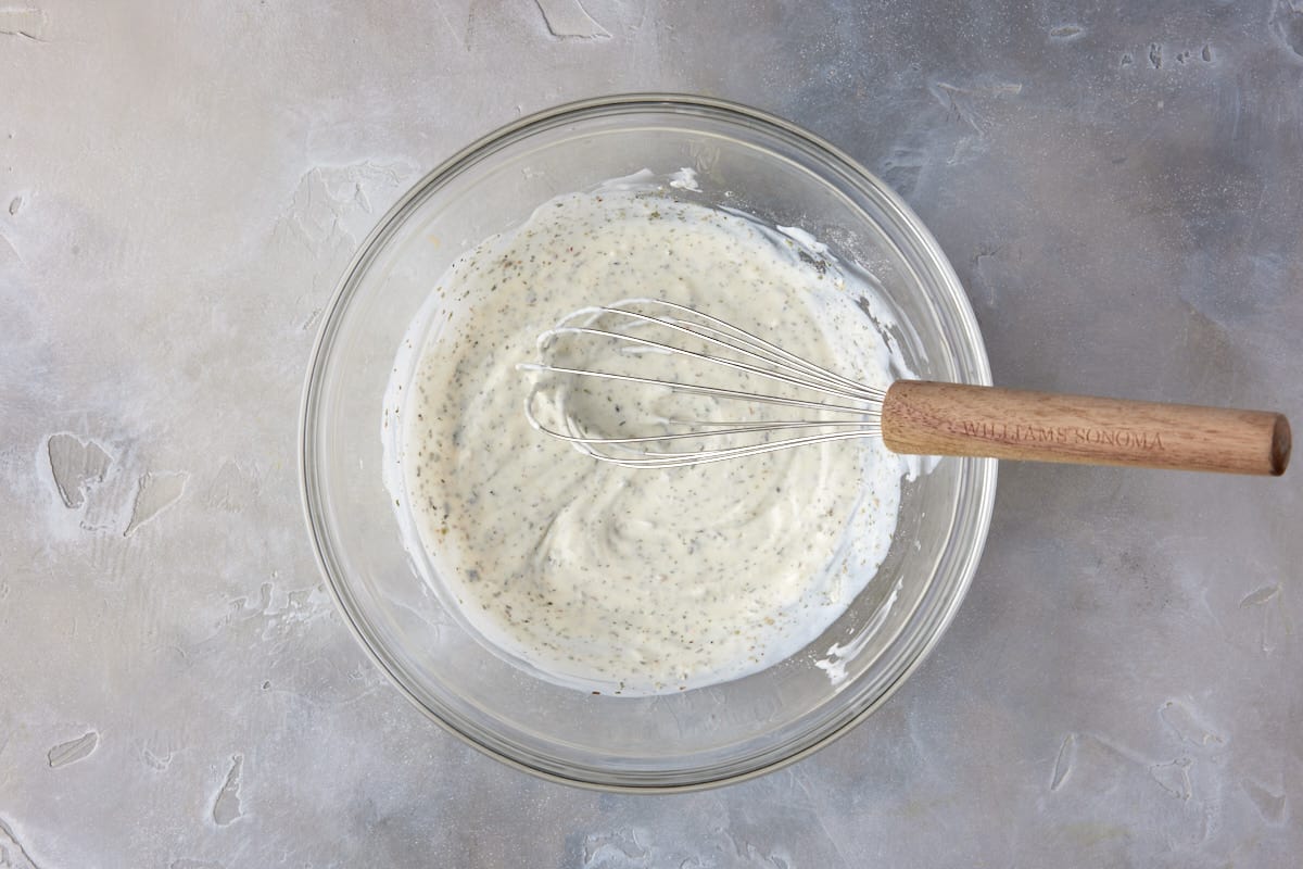 Seasonings mixed in bowl with buttermilk and mayo.