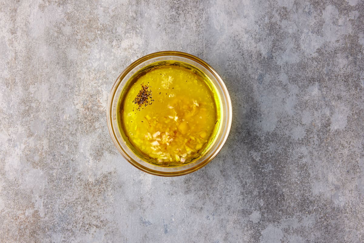 Small glass bowl filled with vinaigrette ingredients. 