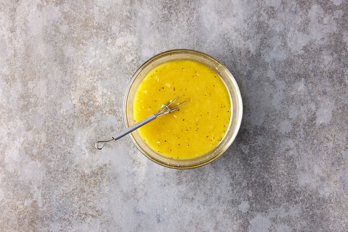 Small glass bowl with prepared citrus vinaigrette. 