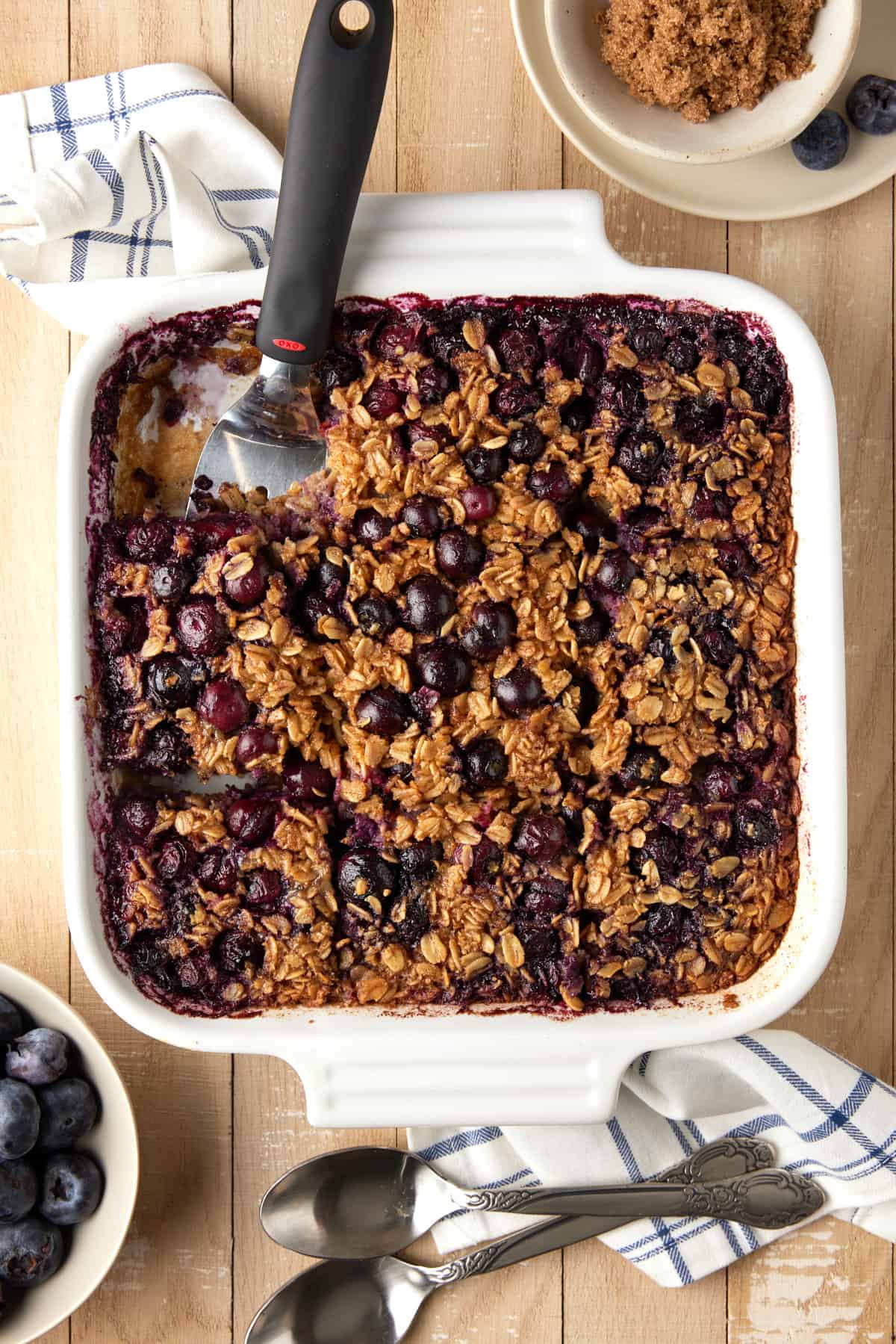 Baked oatmeal with blueberries with brown sugar and fresh blueberries.
