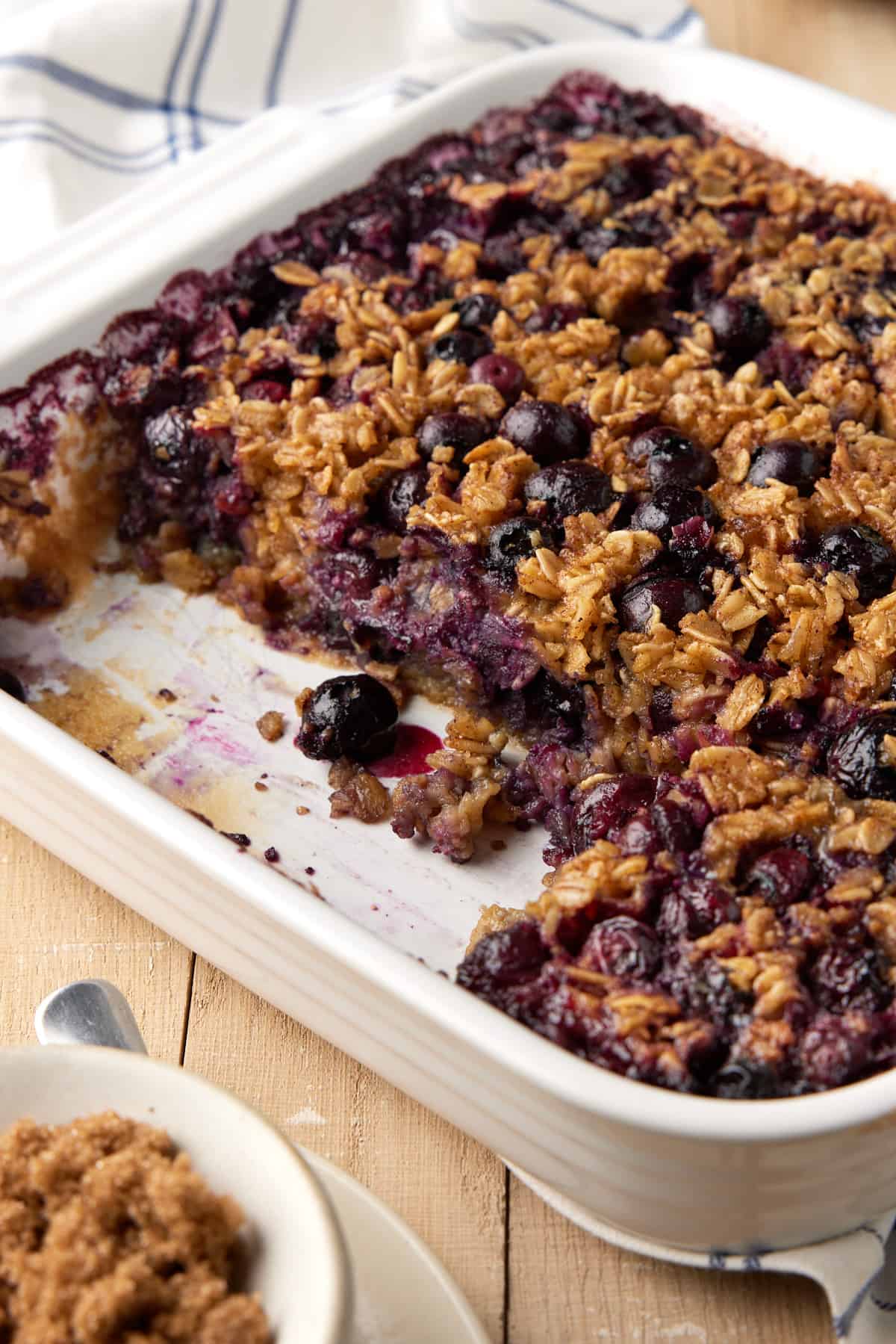 Baked oatmeal in white dish with blueberries.