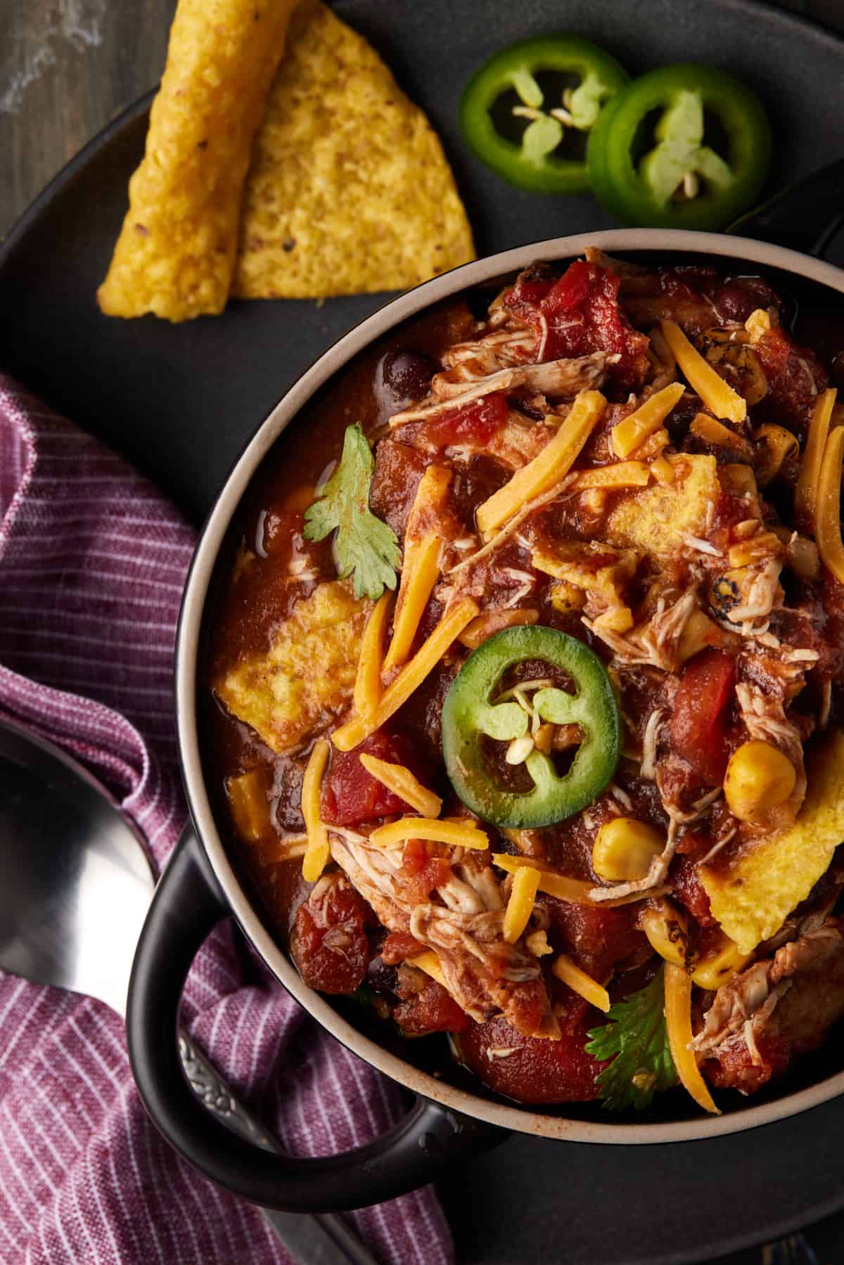 Chicken taco soup with jalapenos and chips.