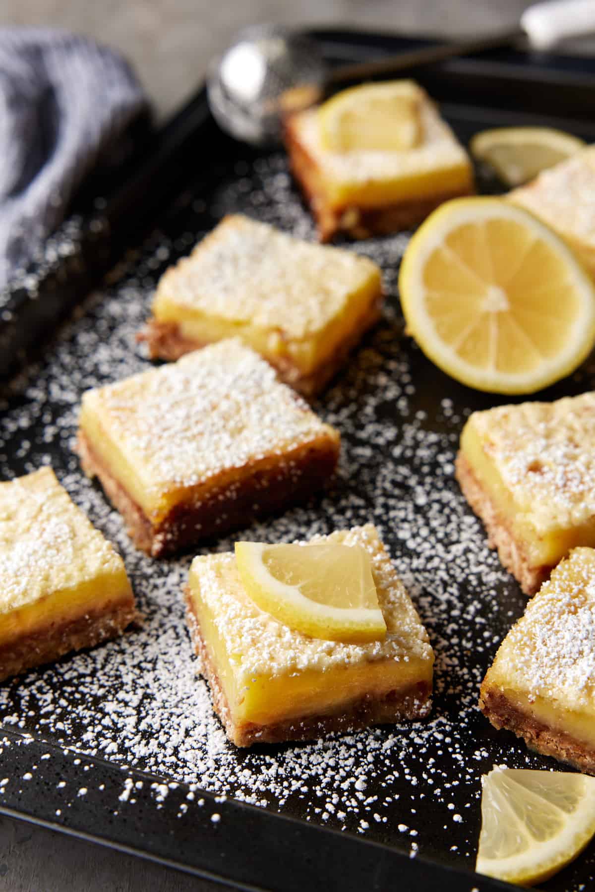 Dark sheet pan filled with coconut lemon bars. 