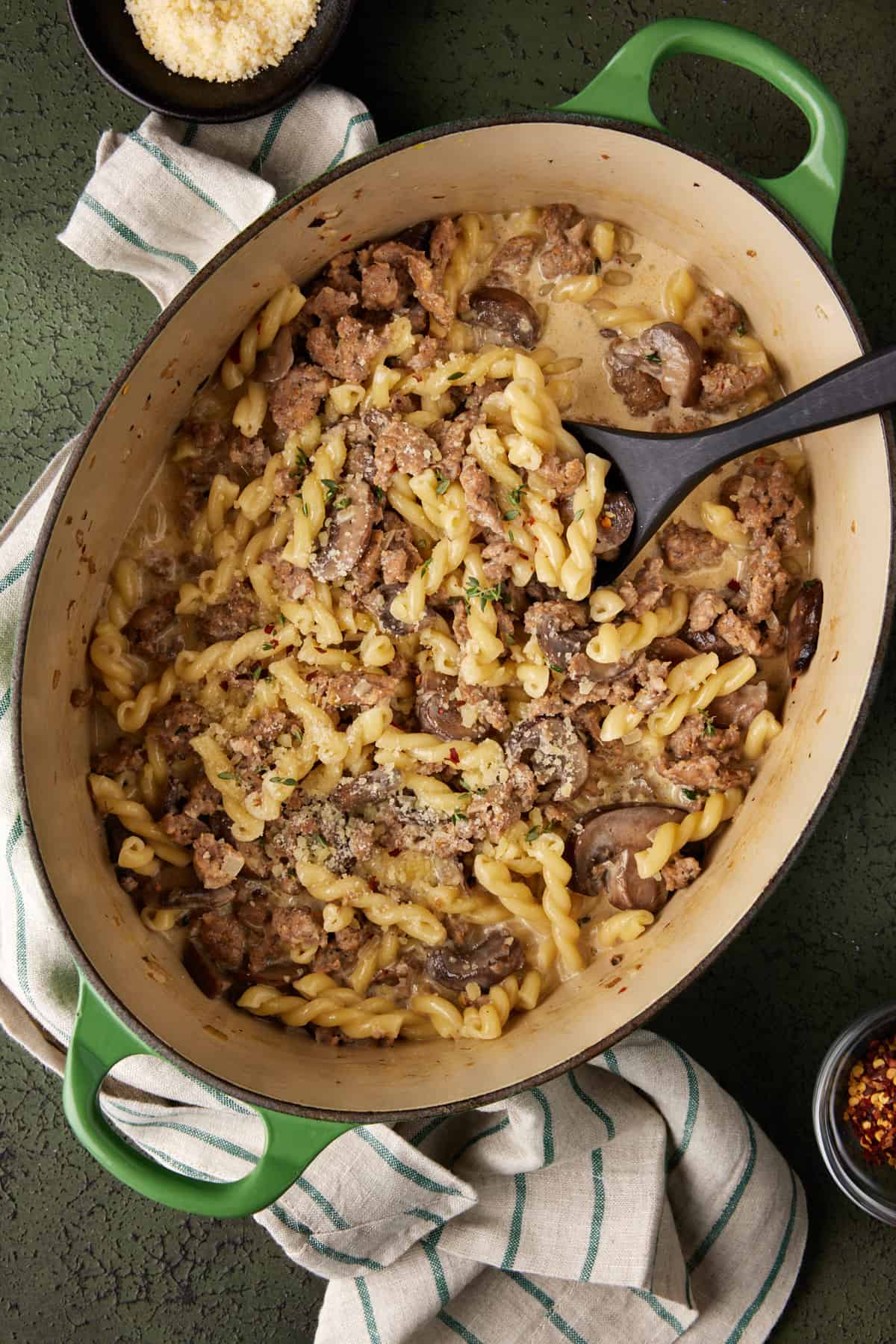Dutch oven filled with creamy sausage gemelli pasta. 