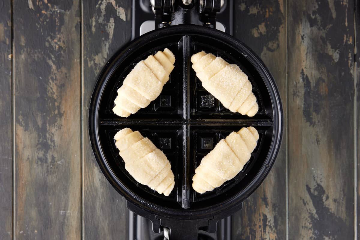 Croissant dough rolled in sugar on a waffle iron. 