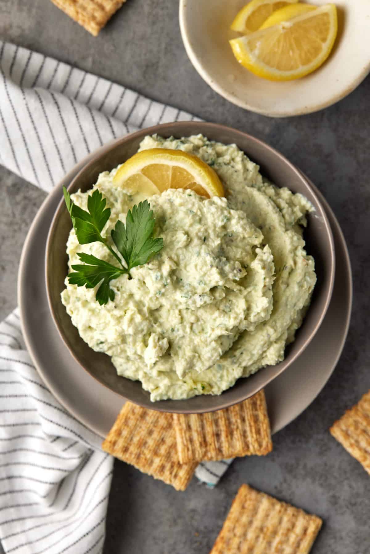 Lemon artichoke dip with crackers.