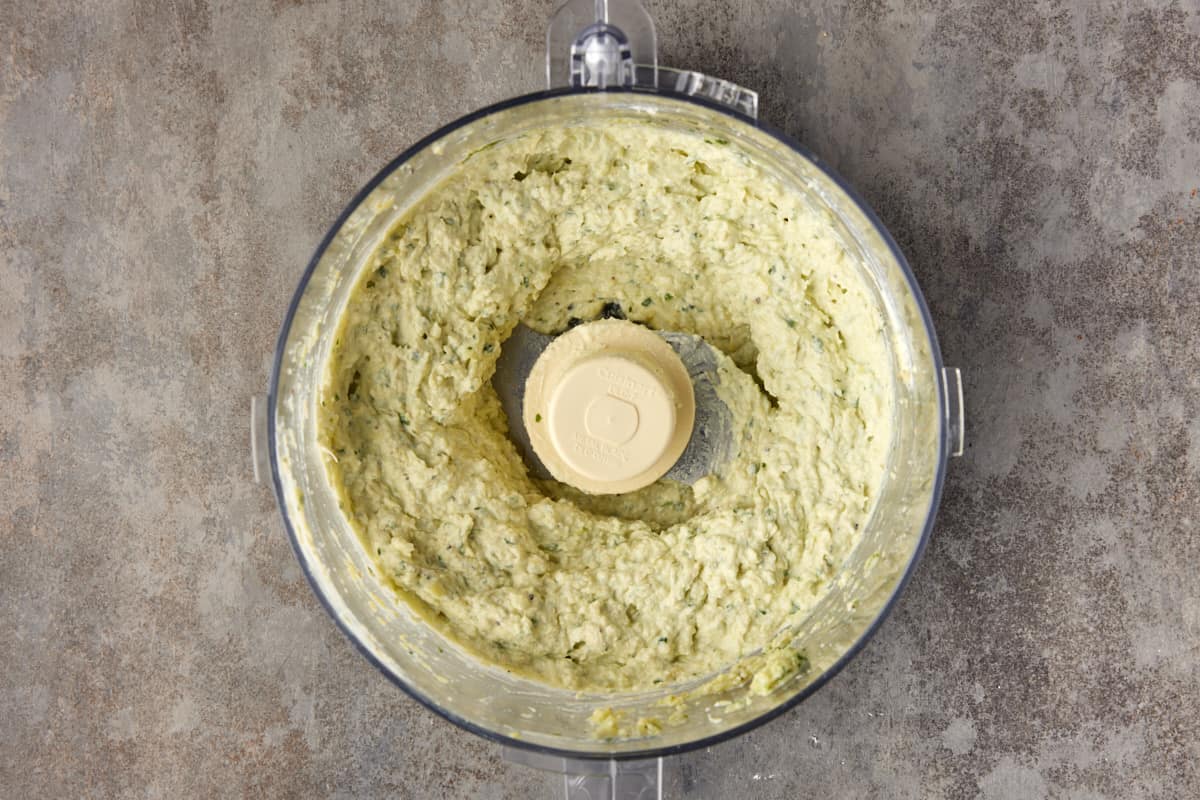 Creamed artichoke dip in food processor.