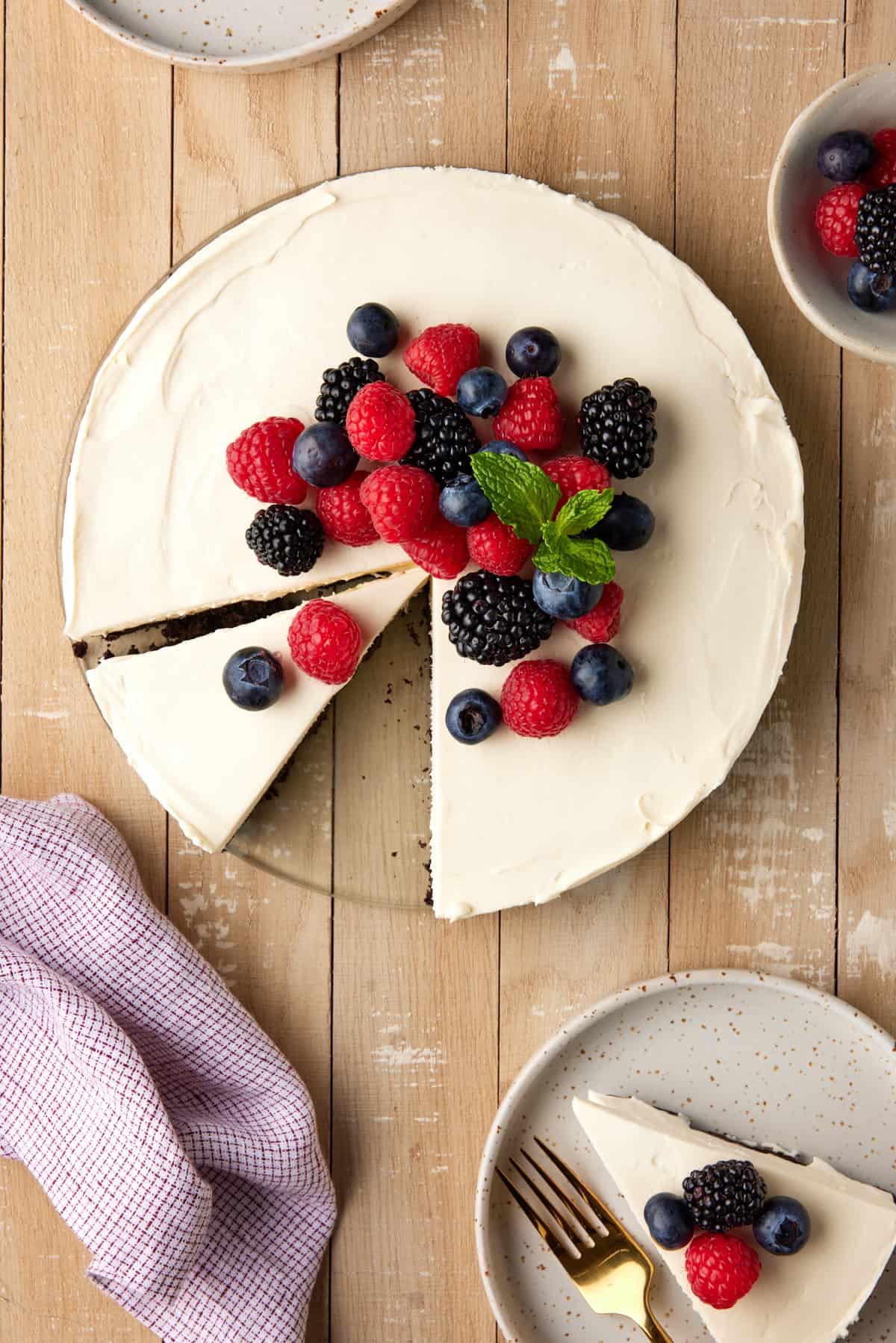 Sliced Mascarpone cheesecake with fresh berries.