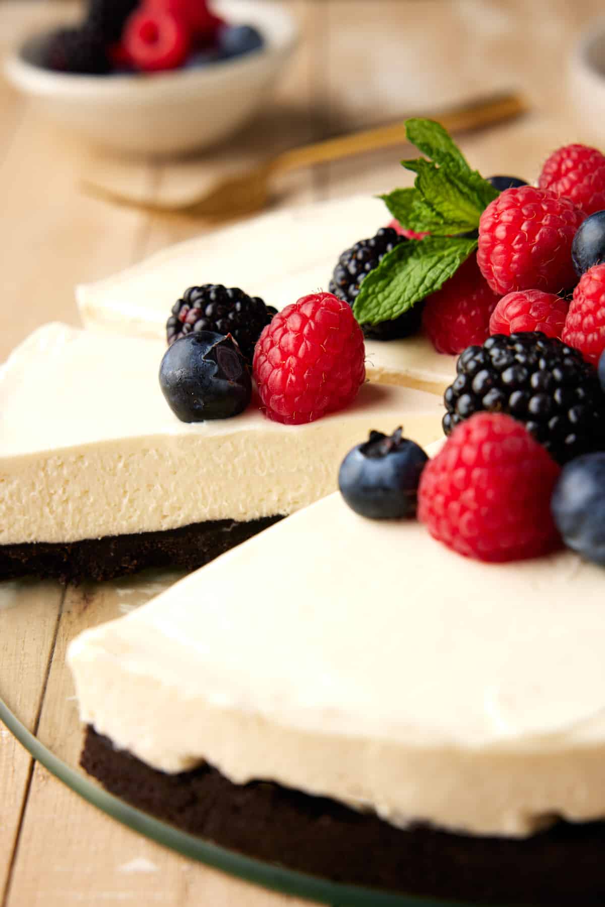 Sliced mascarpone cheesecake with fresh berries.