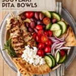chicken souvlaki with pita and fresh vegetables in a bowl.