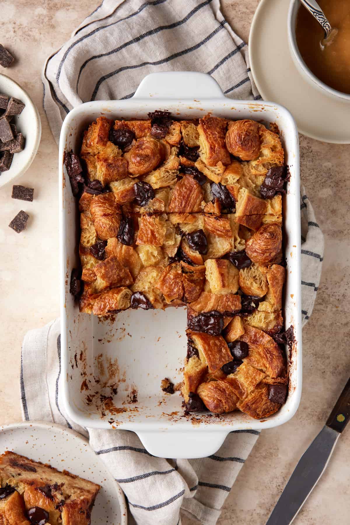 White casserole dish filled with slices of Chocolate Croissant Bread Pudding. 