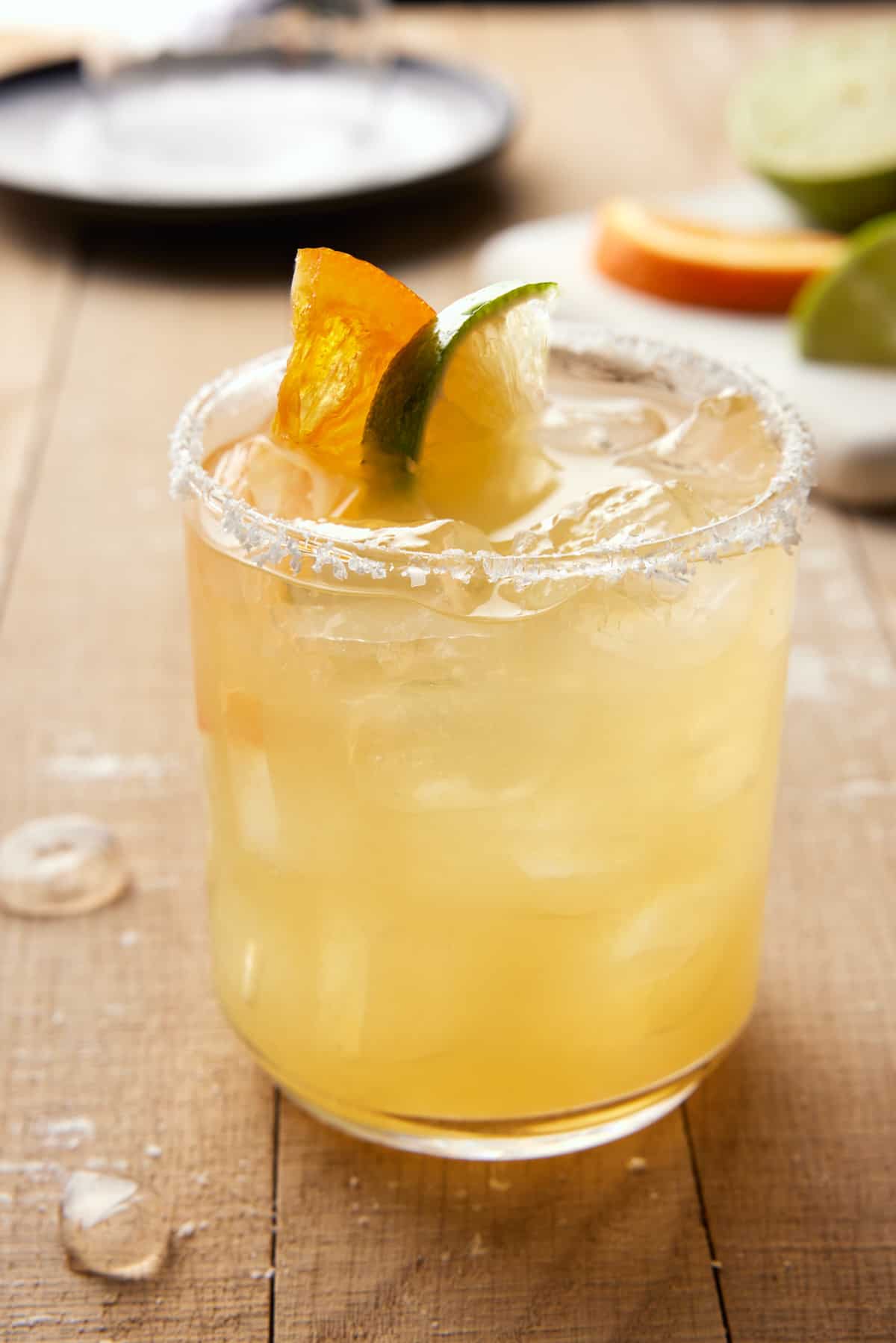 Italian margarita with dried orange slice and lime slice.