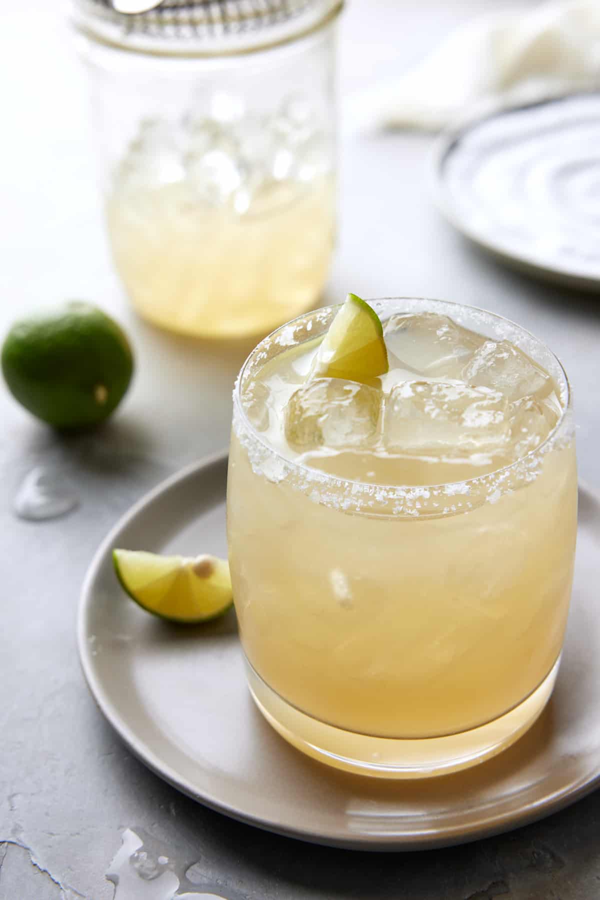 Key Lime Margarita in low ball glass with salt rim.