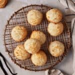 Coconut macaroons on a copper cooling rack.