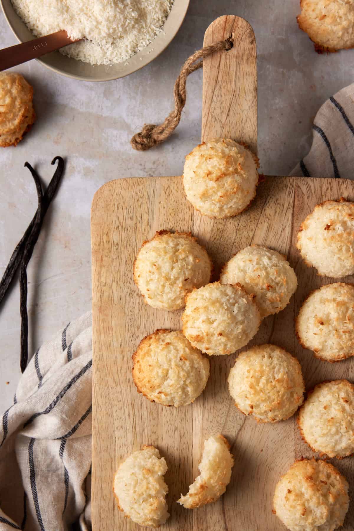 Coconut Macaroons on a light wood cutting board. 