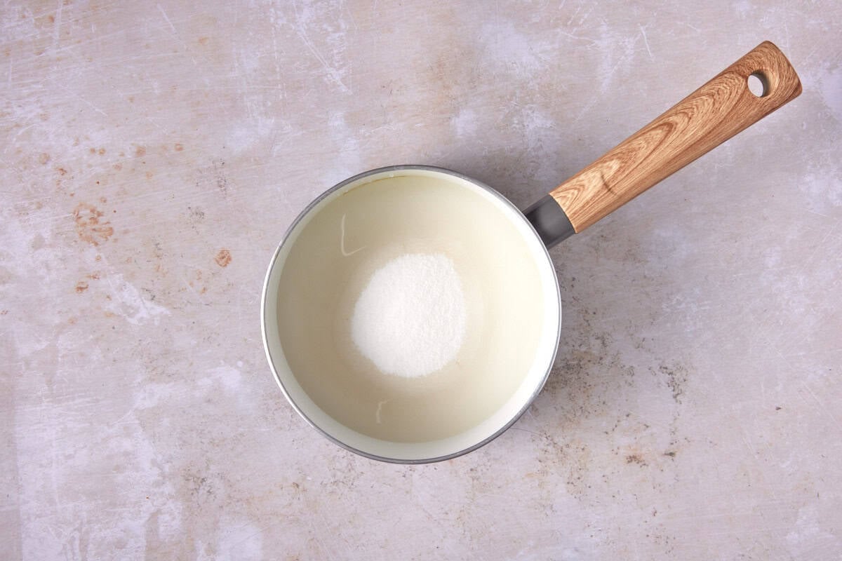 Simple syrup in a white saucepan.