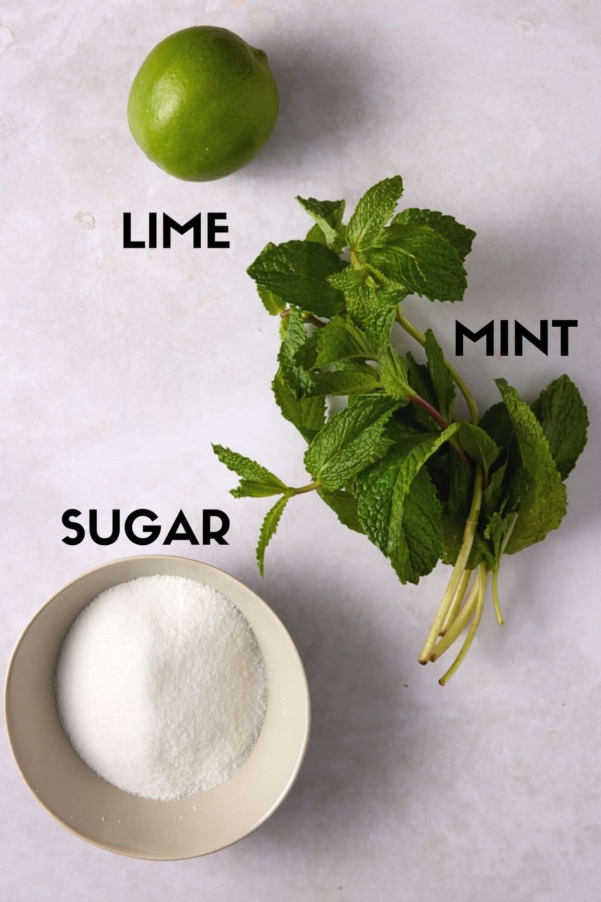 Mint, lime and sugar on a stone board. 
