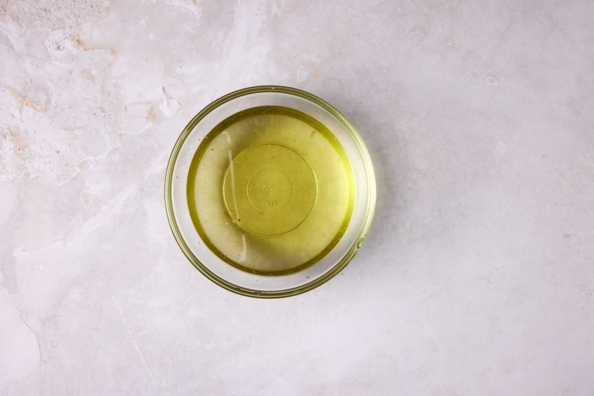 Strained fruit salad dressing in a glass bowl. 