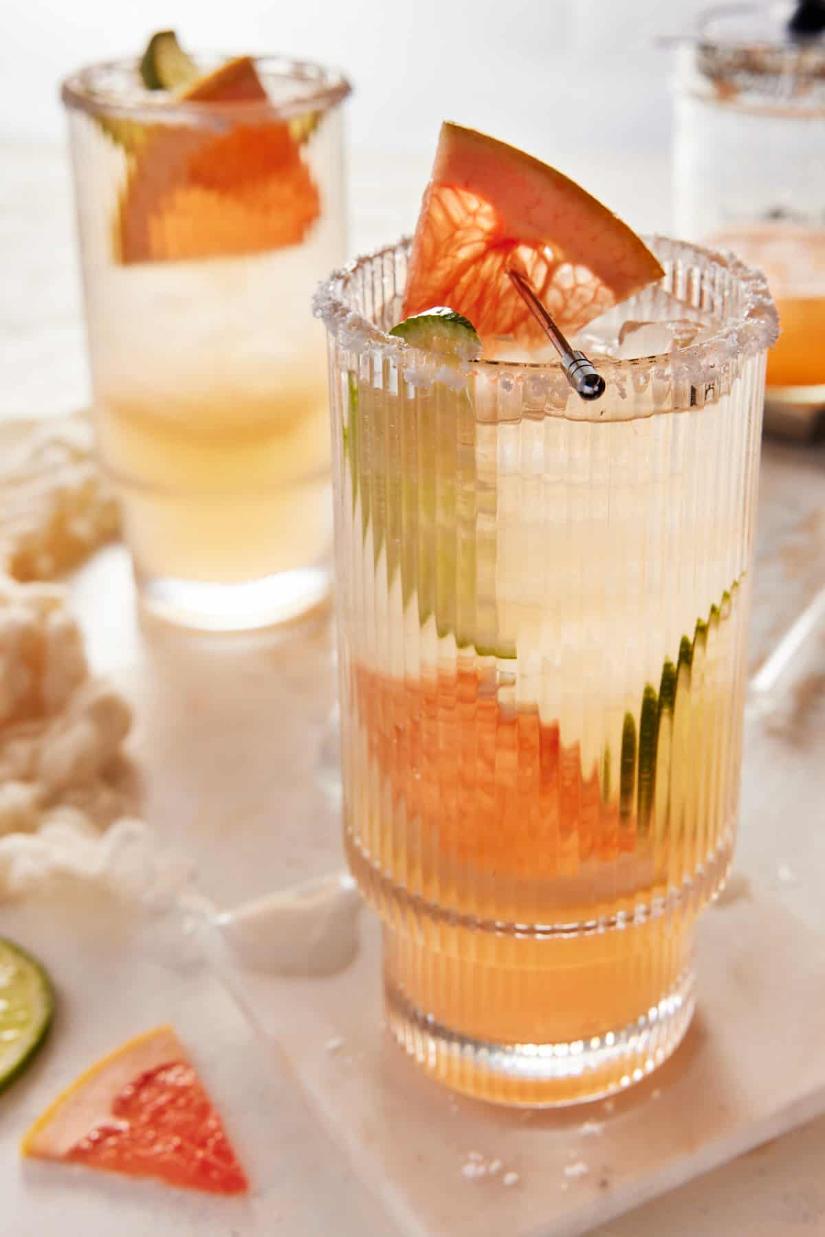 Two grapefruit paloma drinks in highball glasses. 