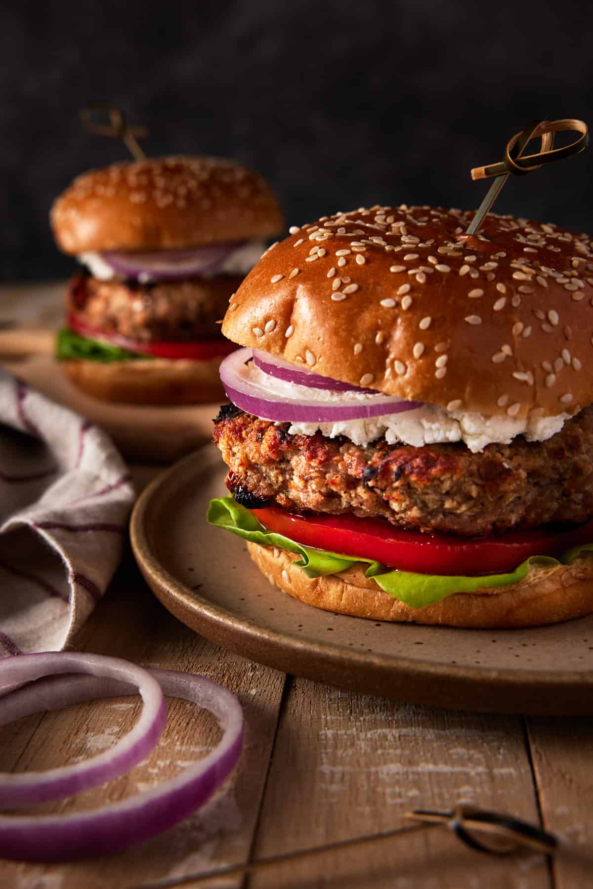 Grilled Turkey Burgers with garnishes on plates.