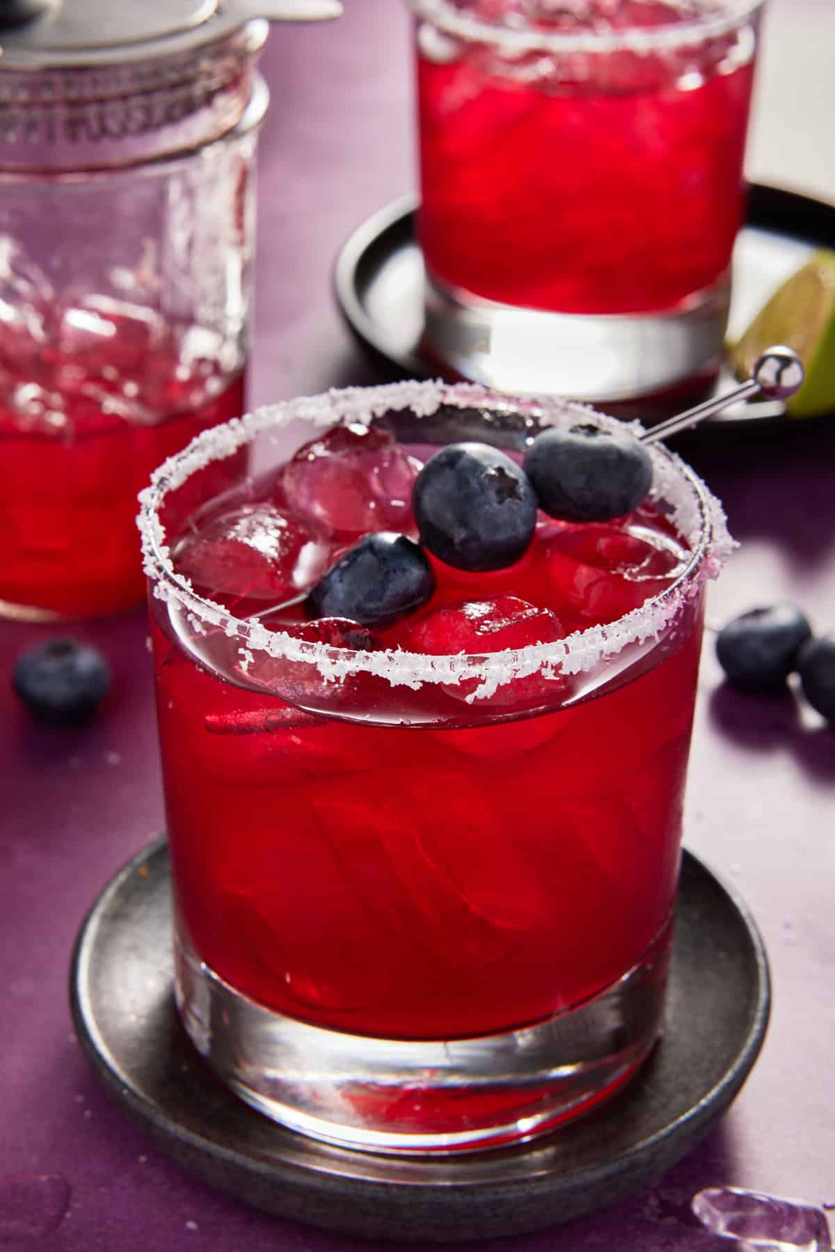 Blueberry Marita in glass with skewered blueberries for garnish.