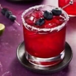 Blueberry Margarita in low ball glass with salted rim.