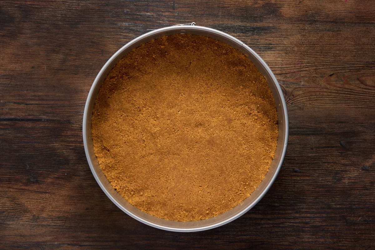 Gingersnap crust in a round metal springform pan. 