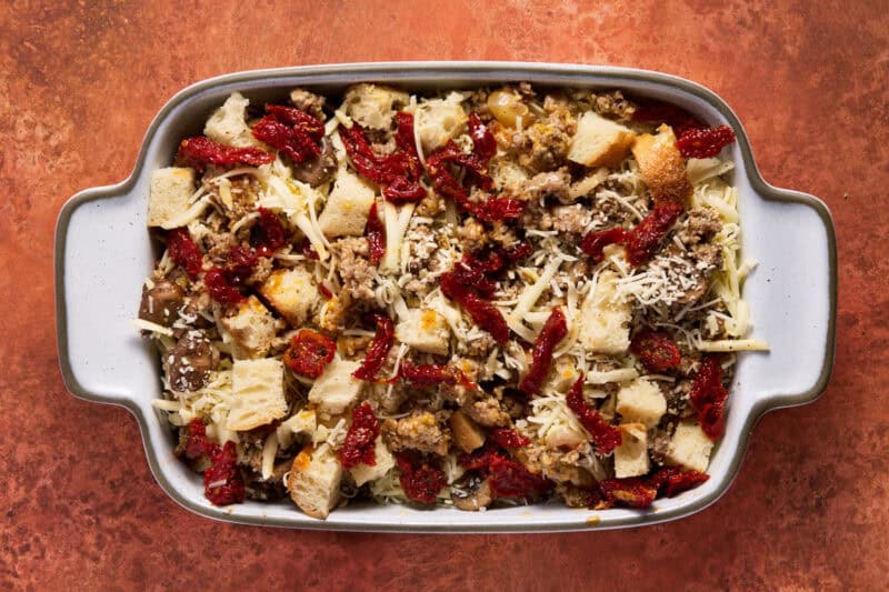 Bread and sausage mixture in pan.