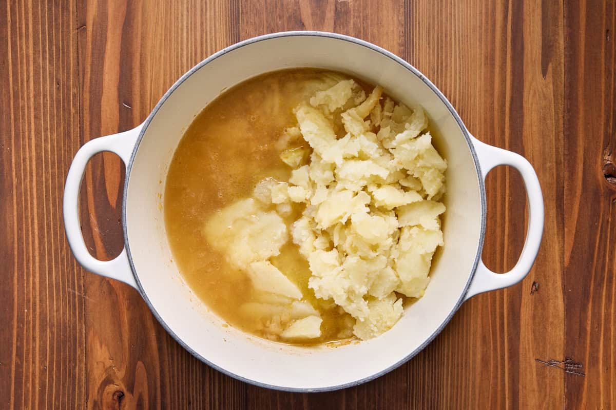 Dutch oven filled with ingredients for baked potato soup. 