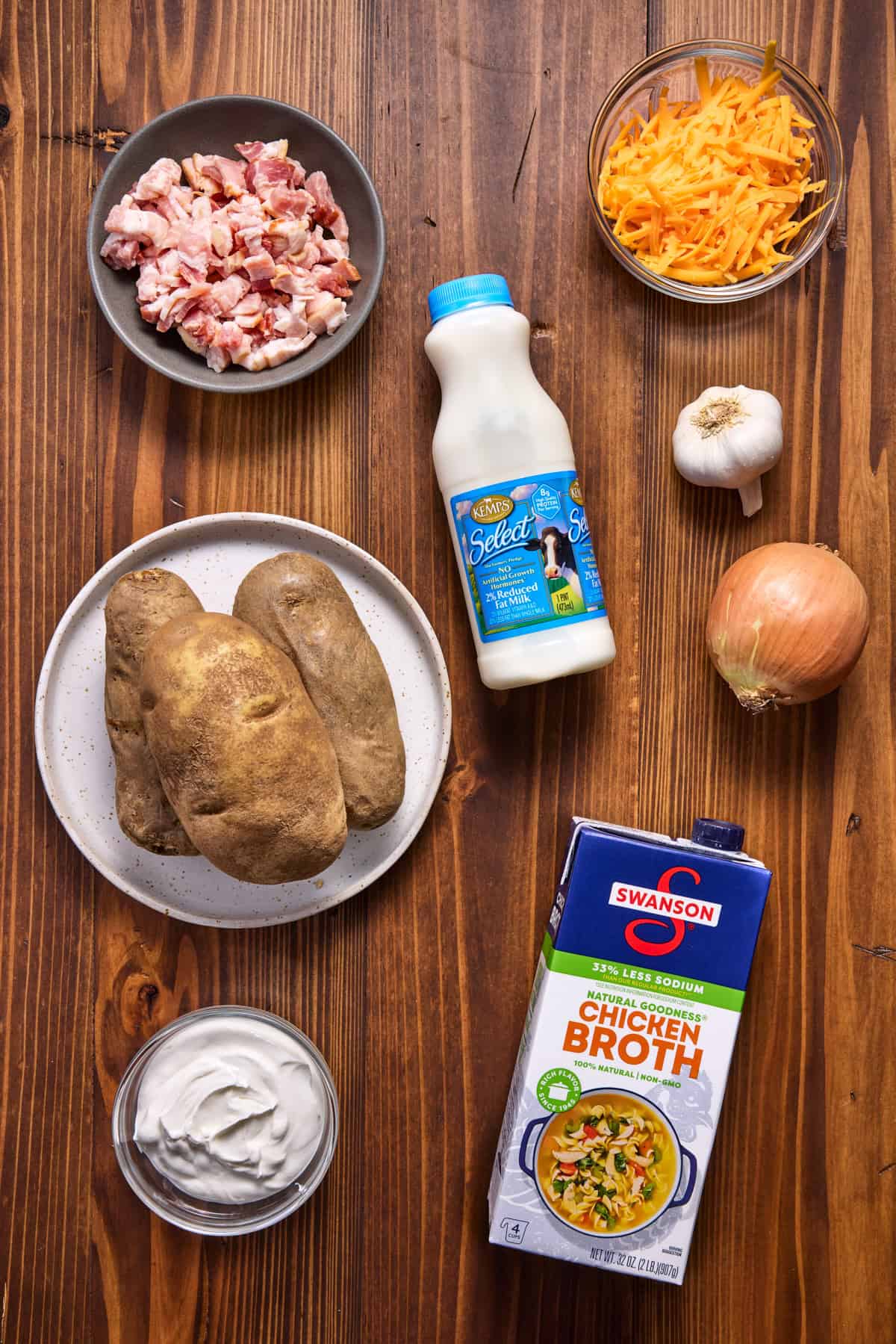 Ingredients for Baked Potato Soup, including potatoes, bacon, cheese and milk. 