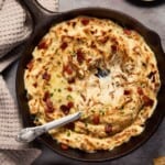cheesy onion dip in cast iron pan.