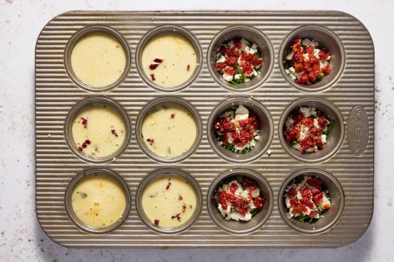 Egg muffin batter in a muffin pan.