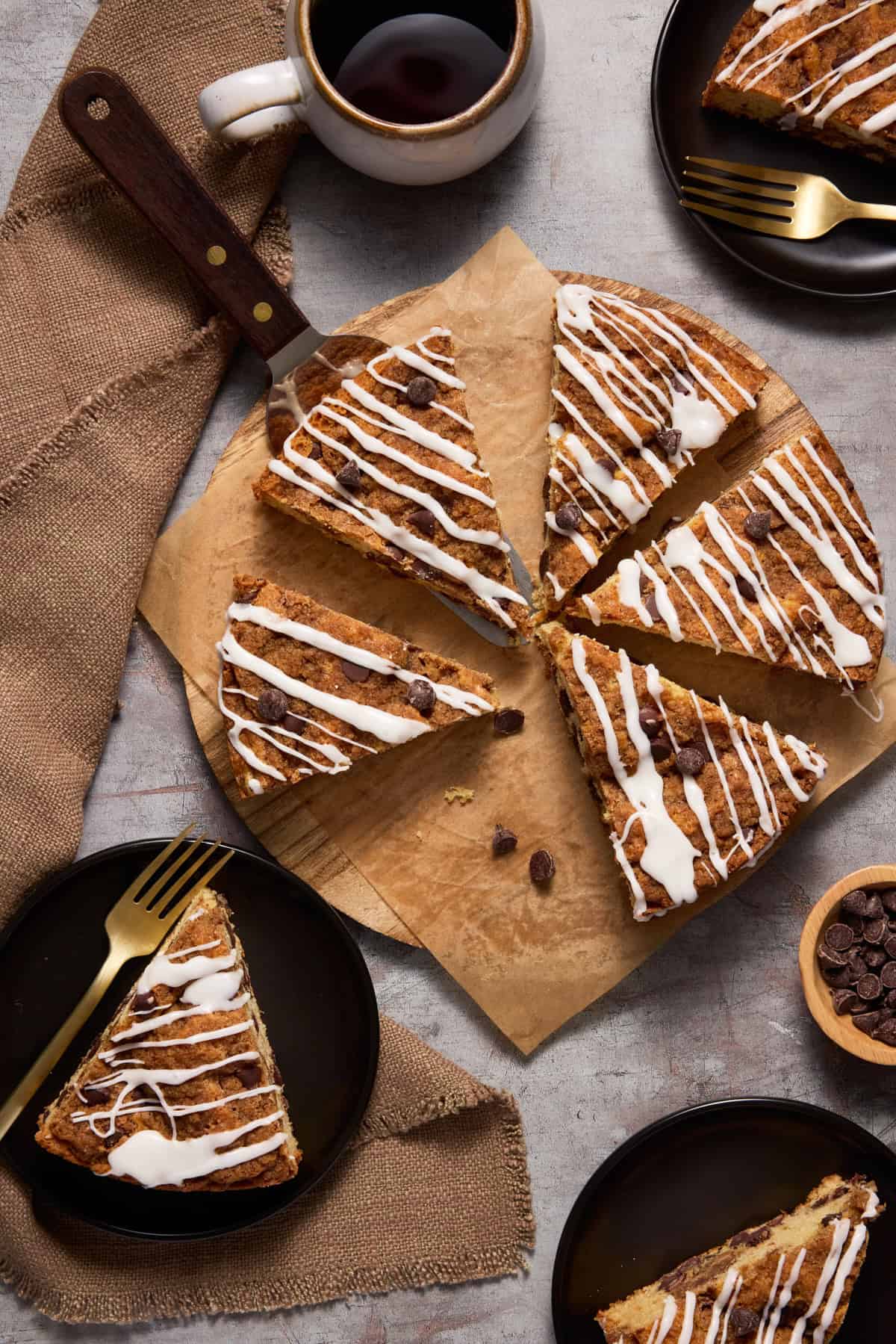 Coffee cake on platter and plates, ready to eat.