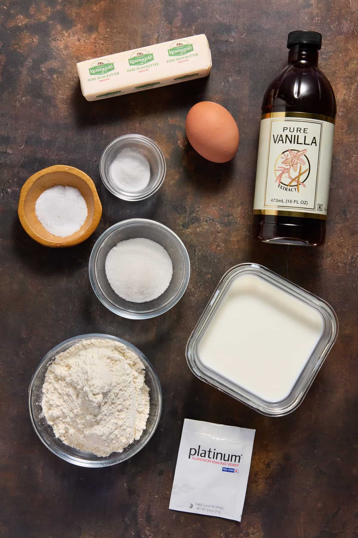Ingredients for overnight yeast waffles on a dark wood board. 