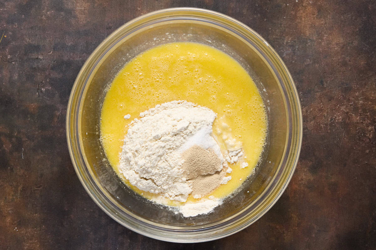 Butter, milk, flour and yeast in a glass bowl. 