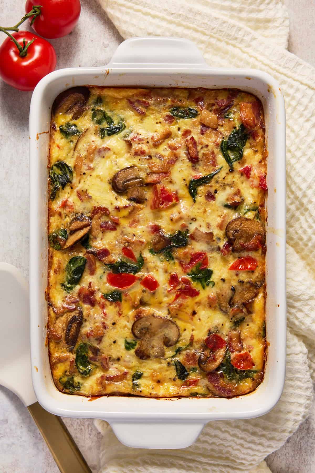 Fully cooked egg bake with spinach, mushrooms and tomatoes.