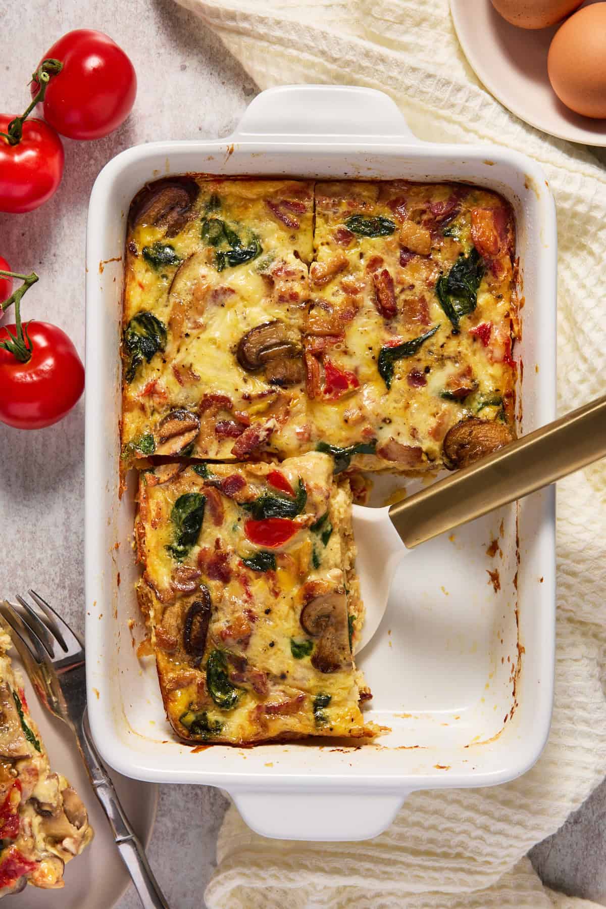 Hash brown egg bake that is cut into 4 pieces and one has been removed.
